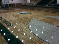 stained inside of 3 poiint circle on this NCAA basketball court
