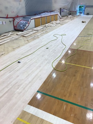 water damaged gym floor restoration replacement repair before the refiishing resurfacing 