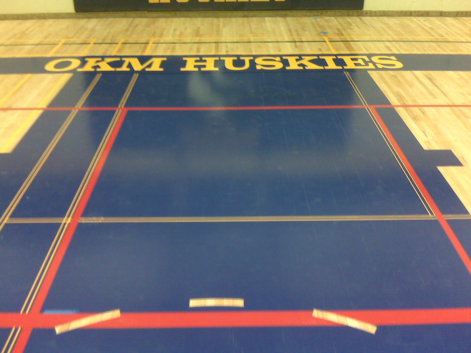 gym floor basketball key blue lettering in cnary yellow gym floor resurfacing refinishihng restoration repair 