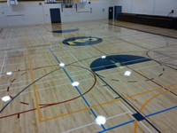 Coquitlam-middle sized gymnasium floor centre logo side courts pratice courts